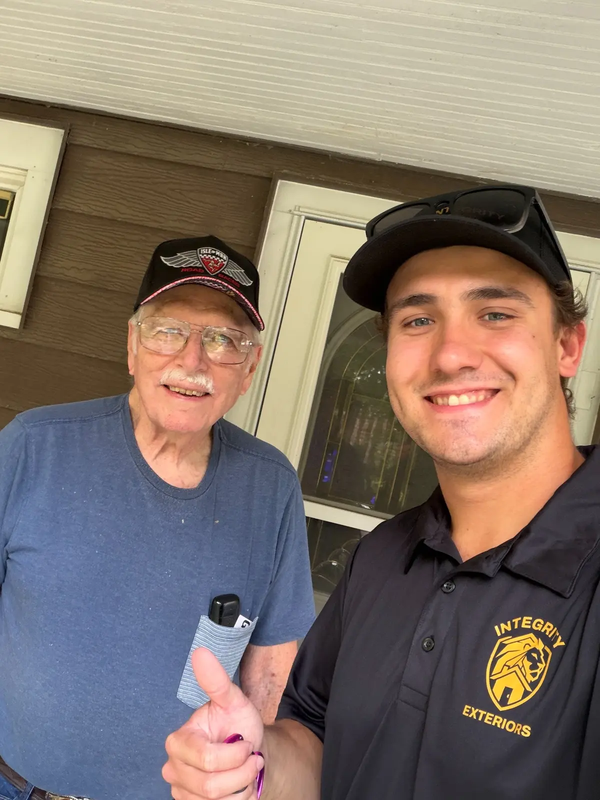 Integrity Exteriors owner Matthew Niles with a customer after gutter service