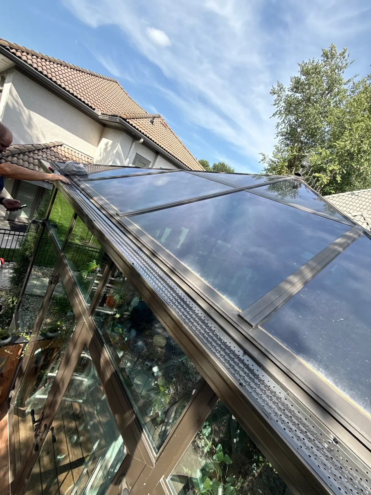 Integrity Exteriors installer fitting gutter guards