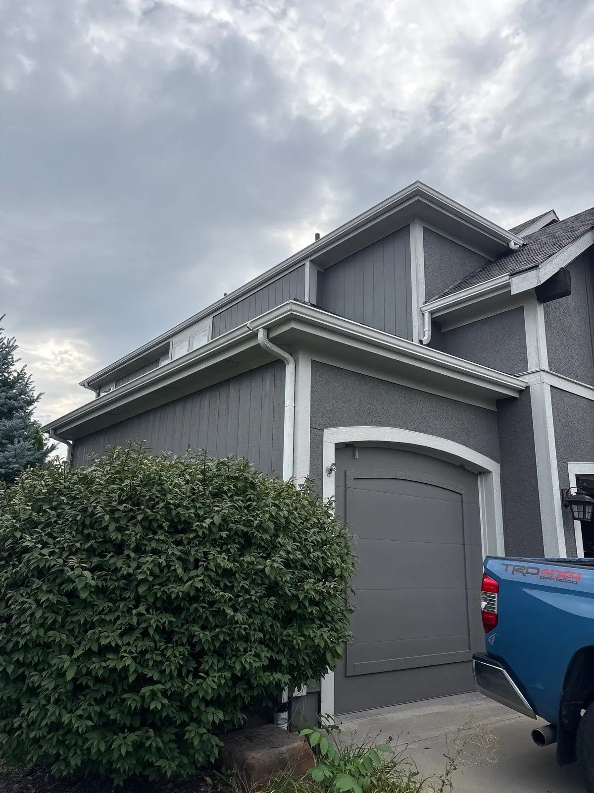 White seamless gutters installed on a two-story home