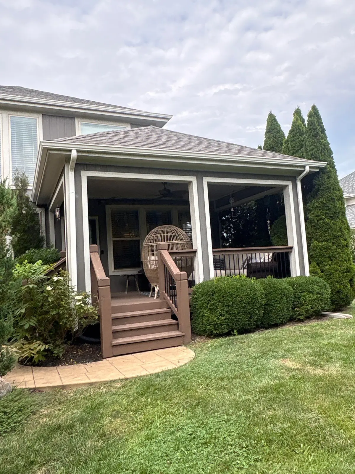 Finished white gutters around a covered porch