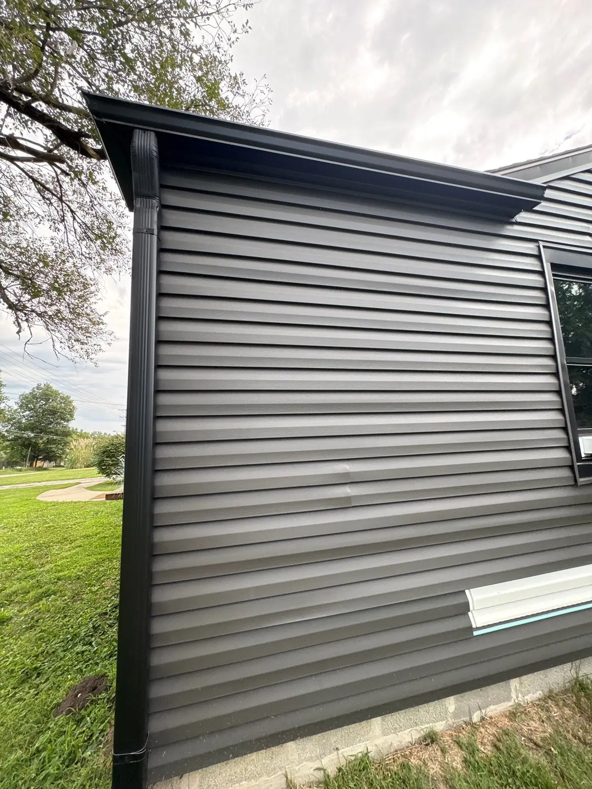 Black seamless gutter and downspout detail