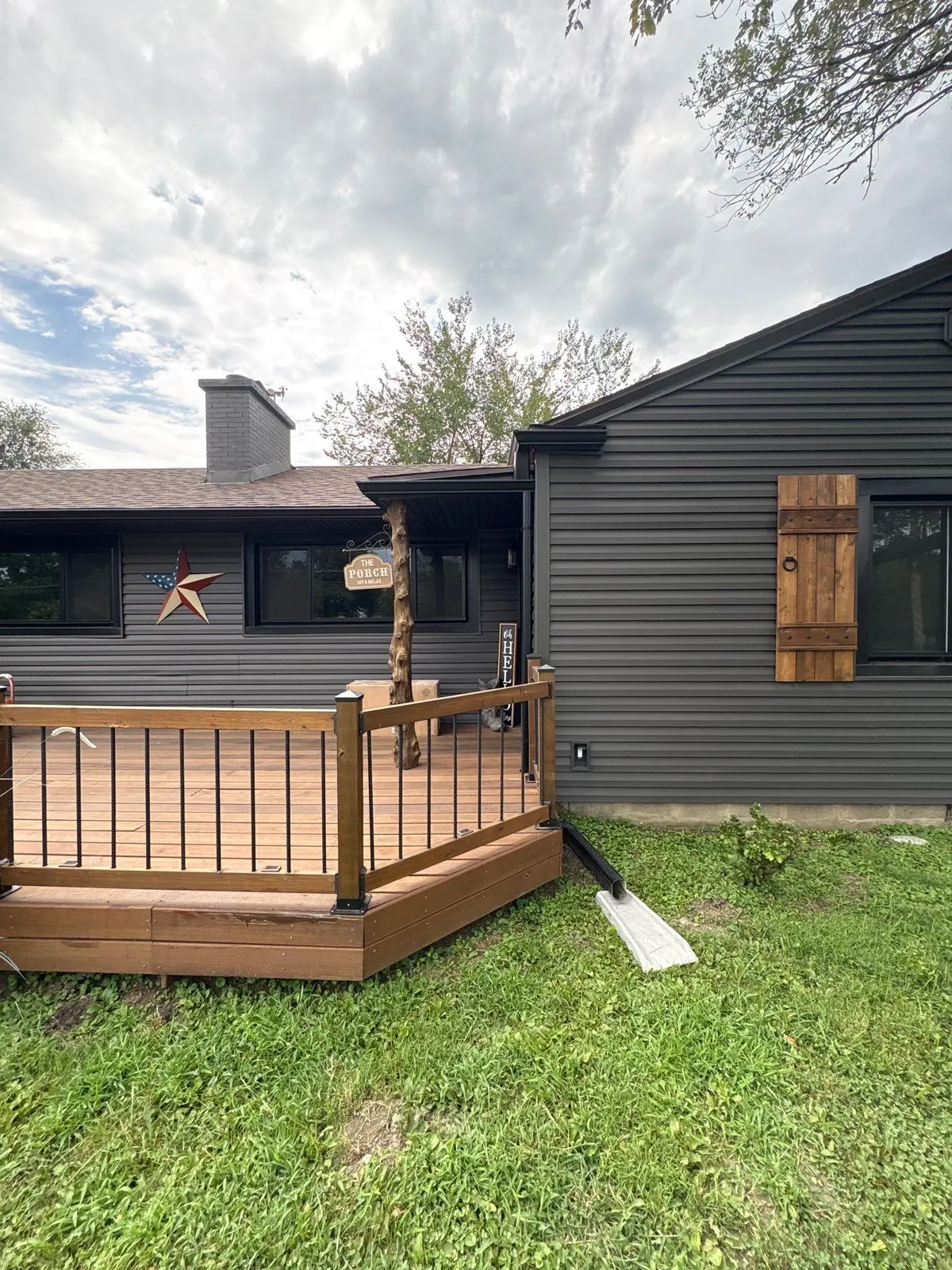 Black gutters and downspouts installed on a dark exterior