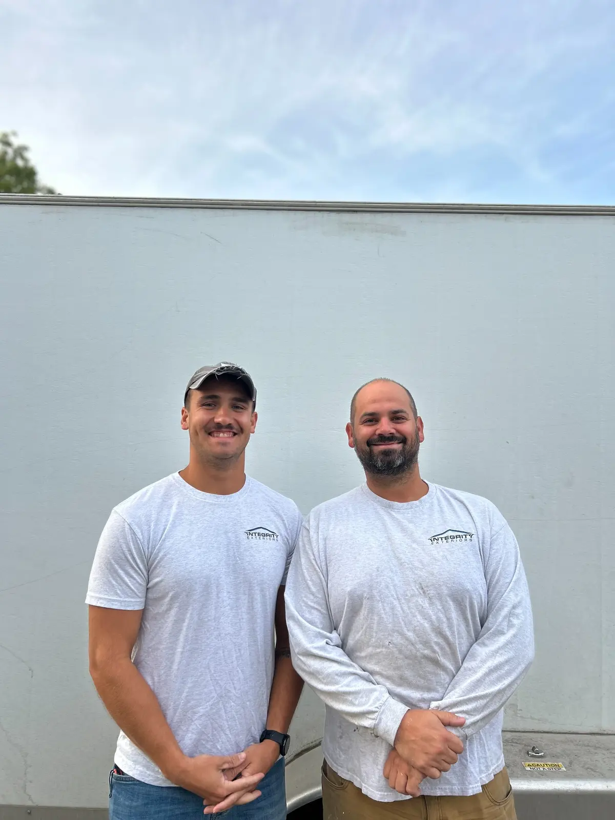 Integrity Exteriors owner Matthew Niles with an in-house team member