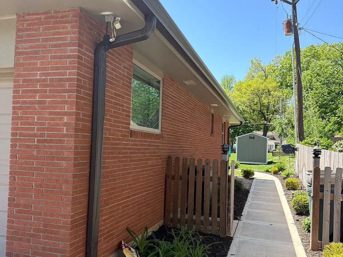 6-inch brown seamless gutters and a 3x4 downspout on a brick ranch in Roeland Park, KS