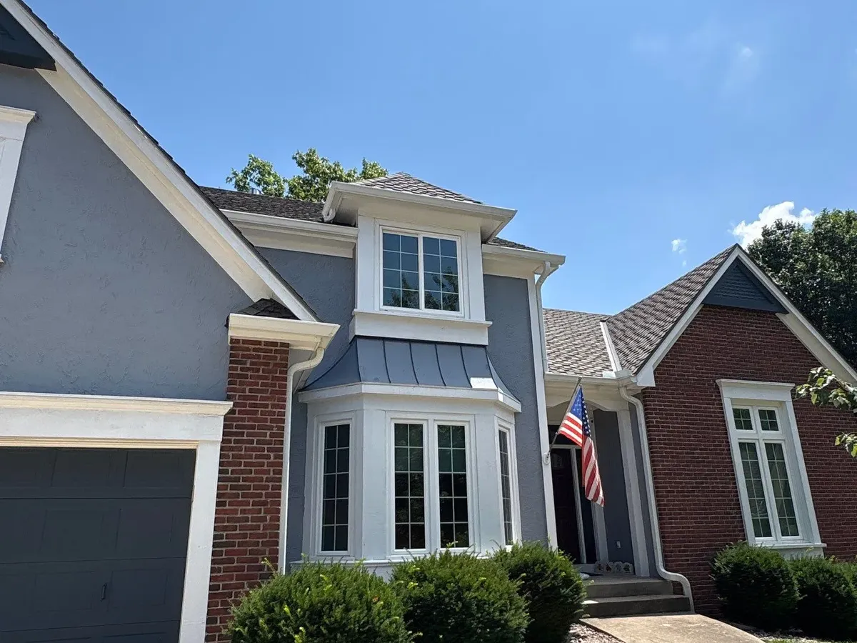 White seamless gutters on a brick and siding home in Parkville, MO