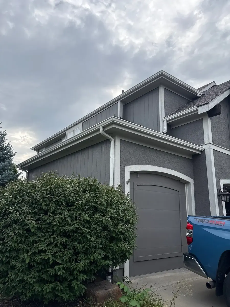 White seamless gutters on a two-story home